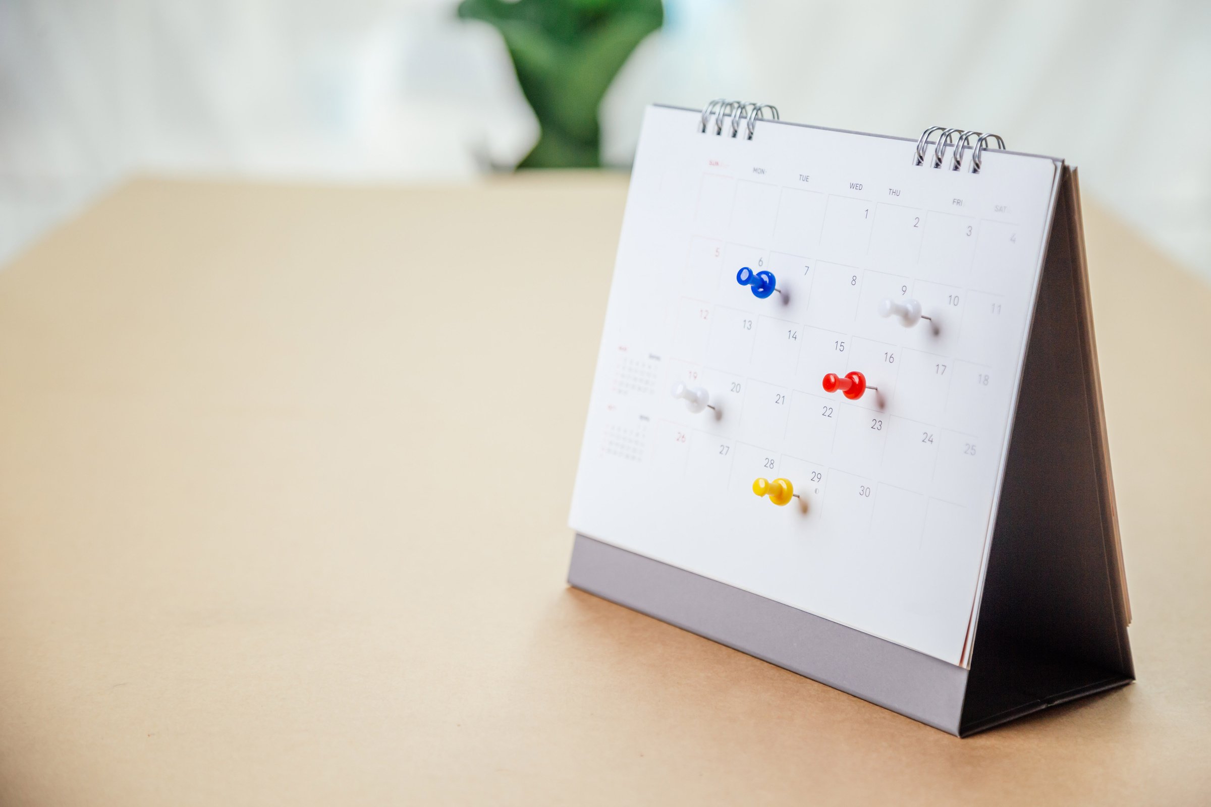 Calendar desk place on the table. Desktop Calender for Planner to plan agenda, timetable, appointment, organization, management each date, month, and year on wooden office table. Calendar Concept.